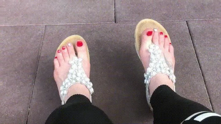 Sandals teasing outdoor with red toenails & toes wiggling