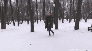 Beautiful girl Alevtina walks barefoot in the winter public park for a long time (Part 1 of 6)