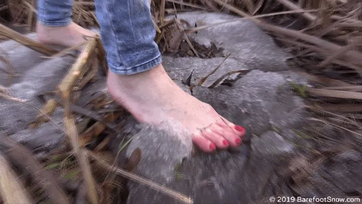 Inna with a red pedicure and soles barefoot on the spring ground and snow (Part 2 of 3)