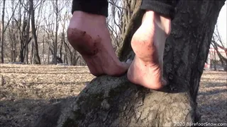 Young barefoot girl Anastasia walks on frozen ground, mud, ice and melt snow (Part 2 of 6)