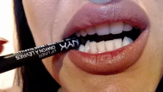 Strong teeth biting a pencil