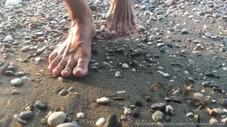 Bare feet covered in algae and sand