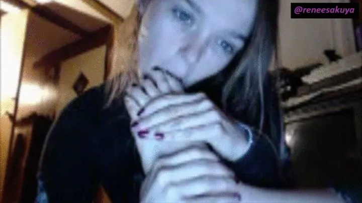 Sucking her own toes, black nail polish