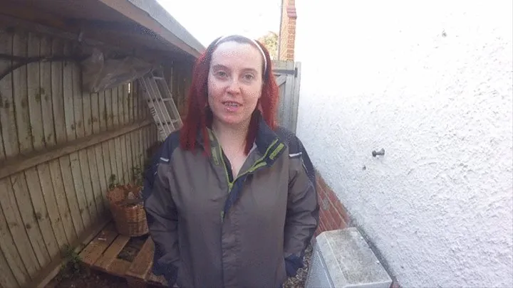 Outdoors in the yard in denim shorts and wellingtons