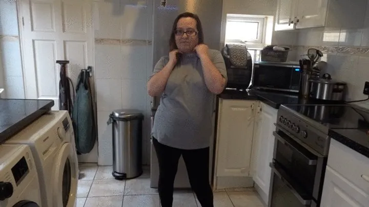 stripping in leggings and bra in the kitchen