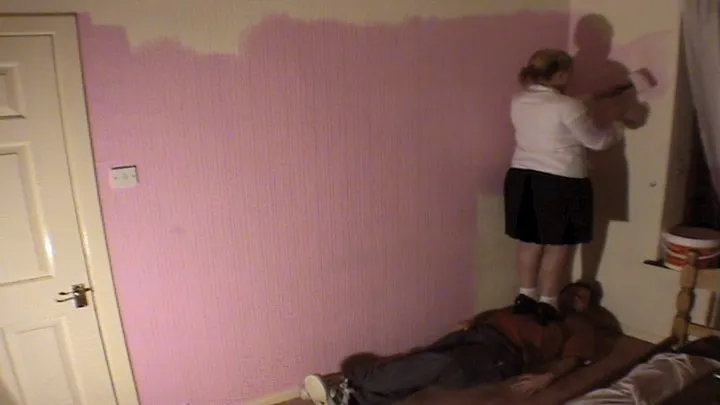 Lisa Paints The Wall Whilst Stood On Her Slave