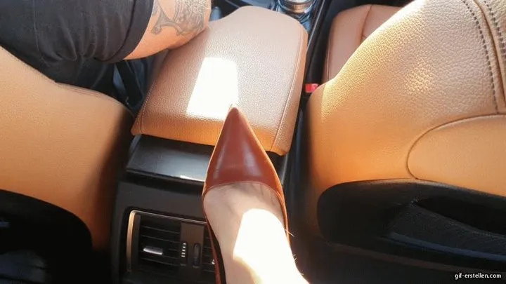 Dangling the shoe in the back seat of the car