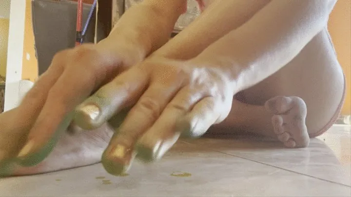 Green dyed fingers caress dirty feet and toes