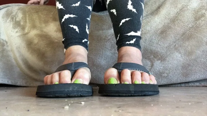 Self pedicure on dirty feet in flip flops