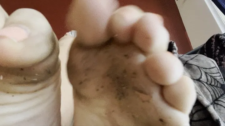 Dirty feet with weird stuff hanging off if them