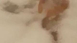 Exotic feet soaking and playing in bubbles