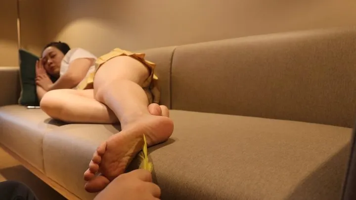 Girl resting on the sofa being tickled