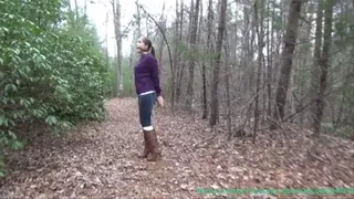 handcuffed walk in the woods in sweater and boots