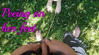 First time pissing on cute brunnete's feet outside