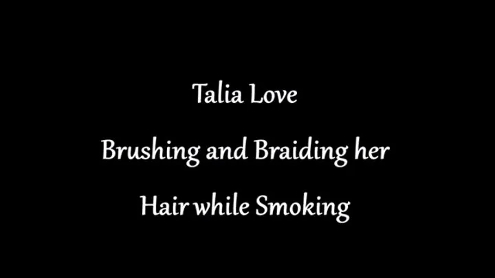 Talia Love brushing and braiding her hair while smoking Marlboro Red 100