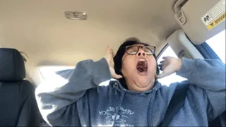 Exhausted yawning in the car