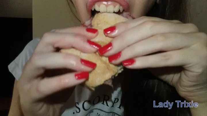 Chewing and eating a sandwich with salami