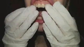 I touch my teeth with white latex gloves