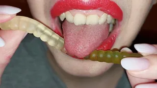 Licking coloured gummy worms