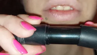 putting a purple lipstick