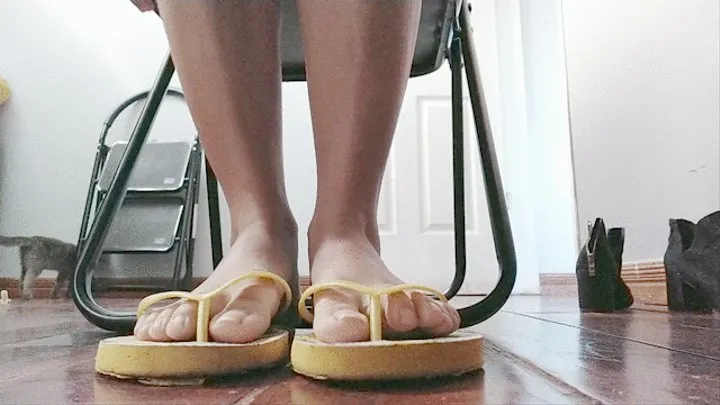 DANGLING YELLOW FLIP FLOPS WHILE WORKING FROM HOME