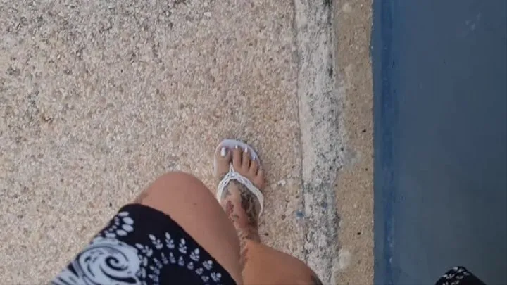 Sweaty Feet in flip flops Walking along the beach on a hot day