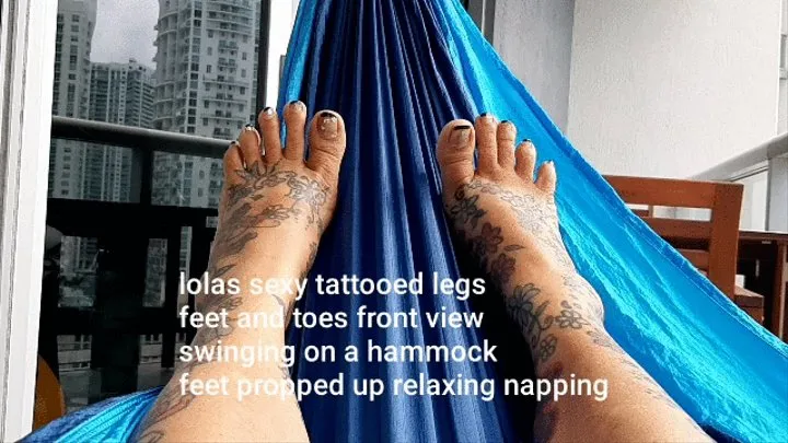 lolas sexy tattooed legs feet and toes front view swinging on a hammock feet propped up relaxing napping