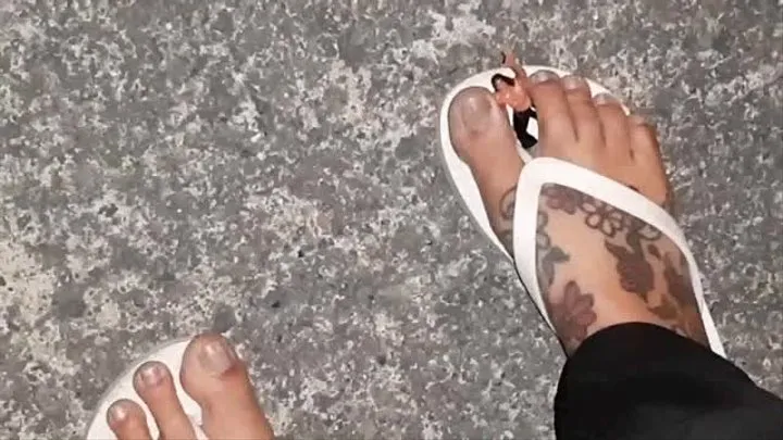 Giantess walks with a tiny man trapped in her flip flops