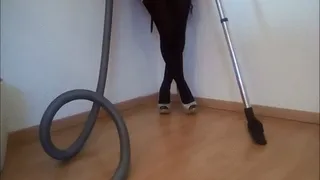 Vacuuming the floor and her black Pantyhose with her silver glitter high heels