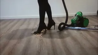 Vacuuming the very dirty floor in high heels