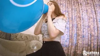 Q500 Leya blows to pop 3 balloons while sitting on Ava