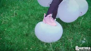 Q112 Ava stomps a buch of 16 inch balloons outdoors