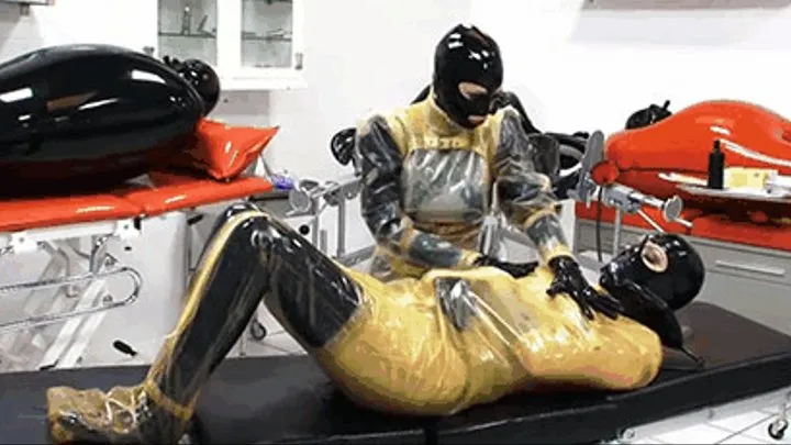 Threesome latex in clinic - Part 1 of 2 - Bondaged in rubber body bag - Slave with ventilation mask