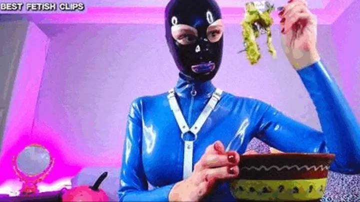 Fantastic rubber girl with latex mask in front of the webcam enjoying her lunch and polishing her fingernails