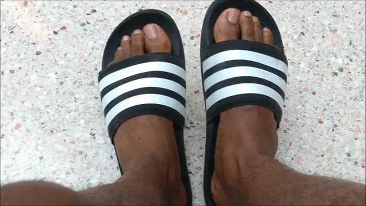 My feet on black and white Adidas slides (2018)