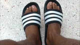 My feet on black and white Adidas slides (2018)
