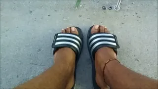 My feet in grey and black Adidas slides (2018)