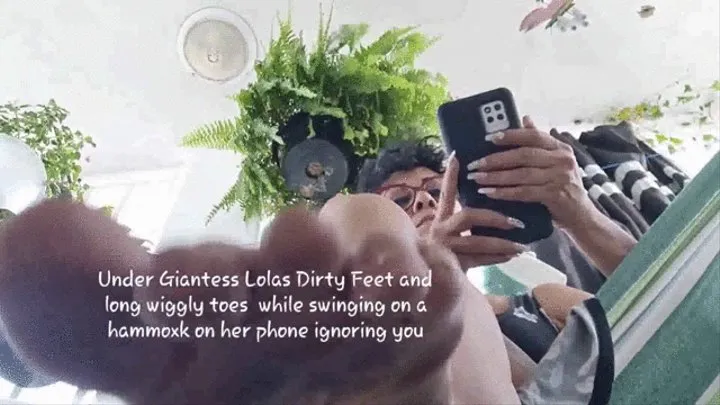 Sexy swinging soles Under Giantess Lolas Dirty Feet and long wiggly toes while swinging on a hammock on her phone ignoring you