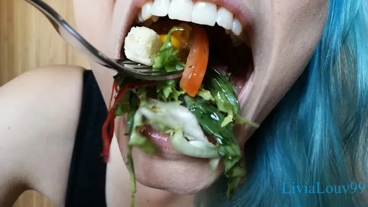 Colorful salad with chicken and croutons chewing