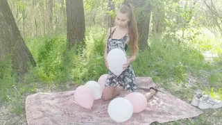 Girl plays and explodes balloons on the nature (part #1)