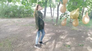 Girl with a stick explodes balloons