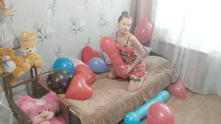 girl playing with balloons of various shapes