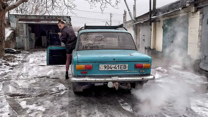 Nastya warms up an old car