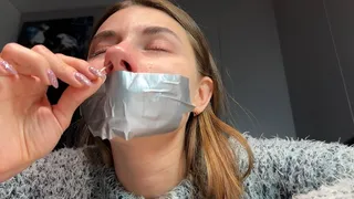 Sneezing with mouth taped and wiping nose with tissues