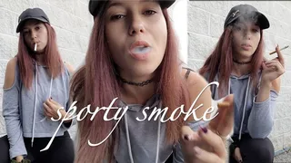 Sporty Looking Girl Smokes a Cigarette