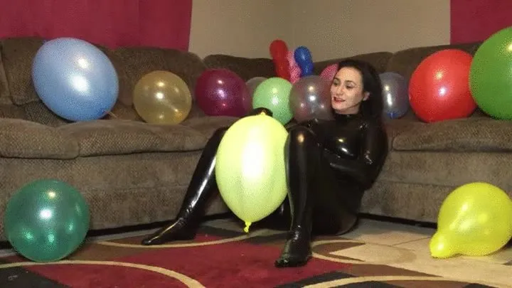 Chloe popping balloons in a body suit