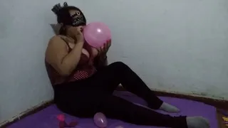 Blowing and sitting pink balloons