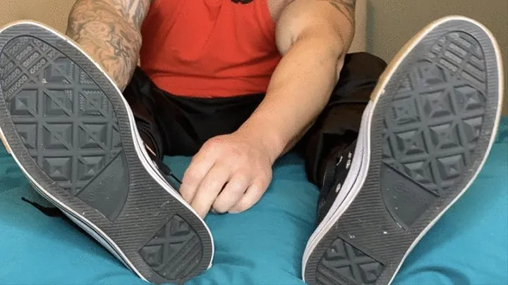 taking off my stinky gym sneakers and socks to reveal my sweaty feet