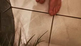 Naked feets after bath in toilet - tread-bend- on dirty floor