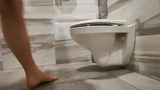 Naked legs in work toilet with dirty floor